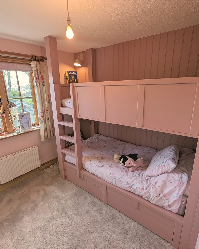 Built-in cabin bed with a panelled surround, steps and drawer storage underneath