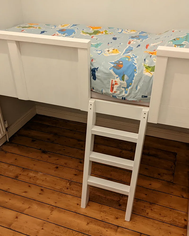 Built-in child's bed with a ladder, made to fit an awkward small bedroom
