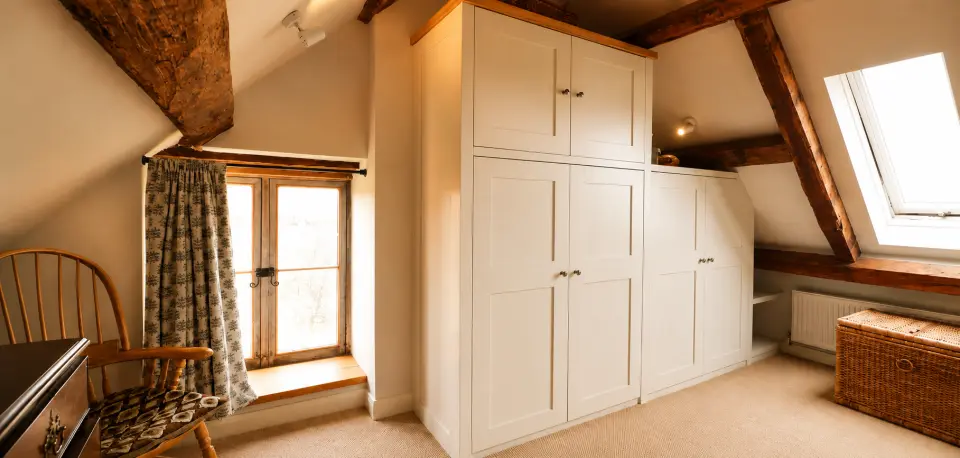 Bespoke fitted wardrobes built into the eaves of a Brecon Beacons cottage