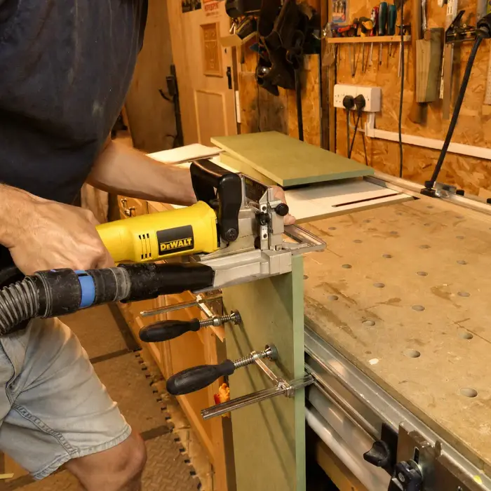 Cutting a biscuit joint at the workshop bench